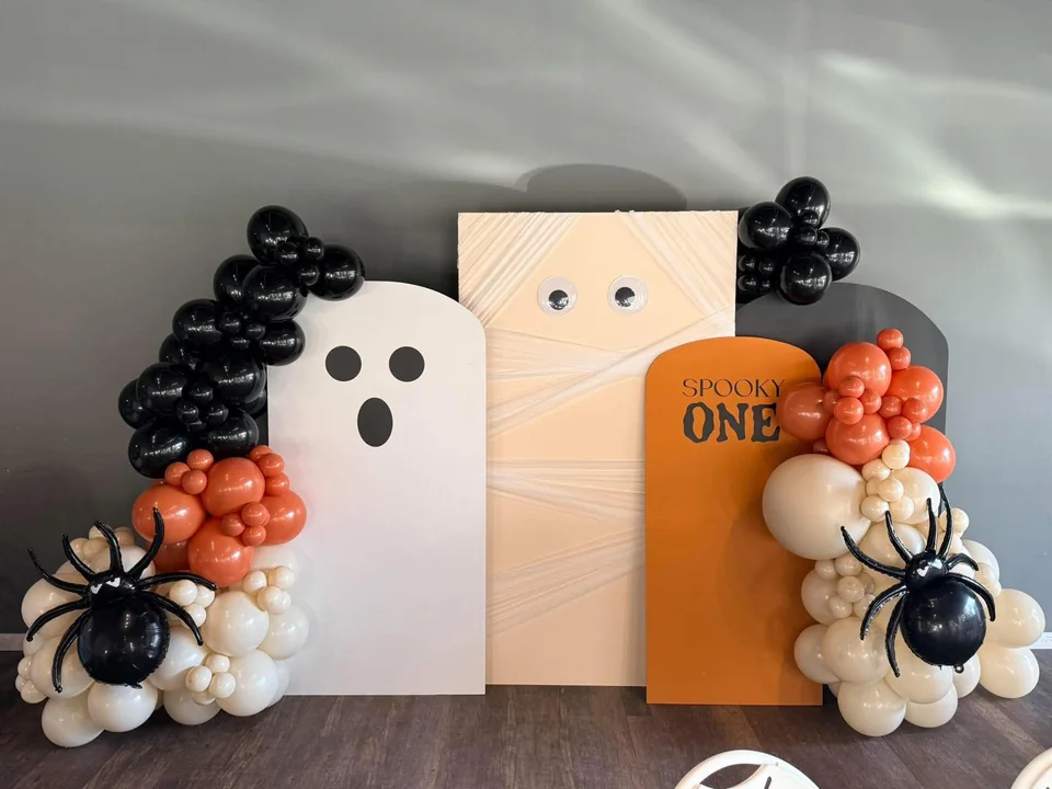 Ghost, mummy and Spooky One backdrops with orange, cream and black balloon installations