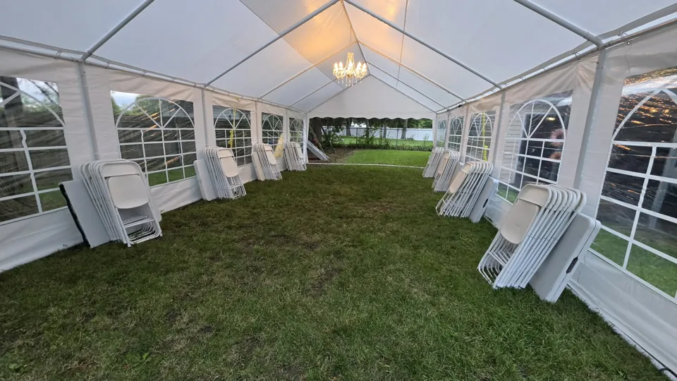 A standard tent installation with window sidewalls and folding furniture ready for arrangement